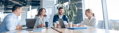 Four employees having a discussion in a meeting room